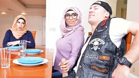 Hijab-wearing damsel providing a hand job from under the table