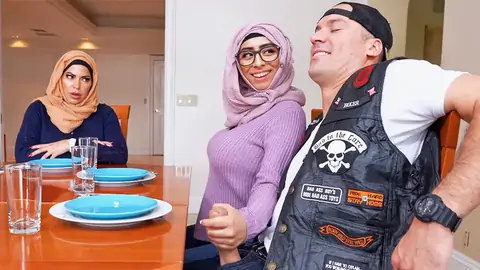 Hijab-wearing damsel giving a handjob from under the table